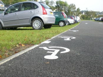 Filename Grassed-Paving-CarPark-France__CIMG0118_640x480.JPG. Grass public parking in France. This is a parking plaza with asphalt lanes and high-traffic parking spaces that are healthy, green, lush grass ... vehicle traffic does not kill the grass when using ecoraster.