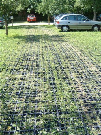Filename Modul3_Hospital-parking-construction-2.jpg. Temporary parking in an orchard for hospital staff for six months. After the project was completed the ecoraster grids were still like new, with no damage  to the tree roots or to the grass. Sustainable, portatble and fully re-usable environmentally sound car parking.